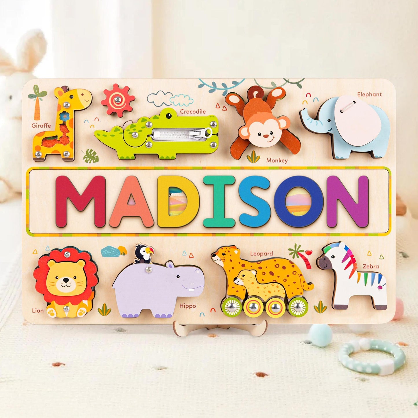 Personalized wooden animal name puzzle busy board for children featuring vibrant animal designs and colorful letters.