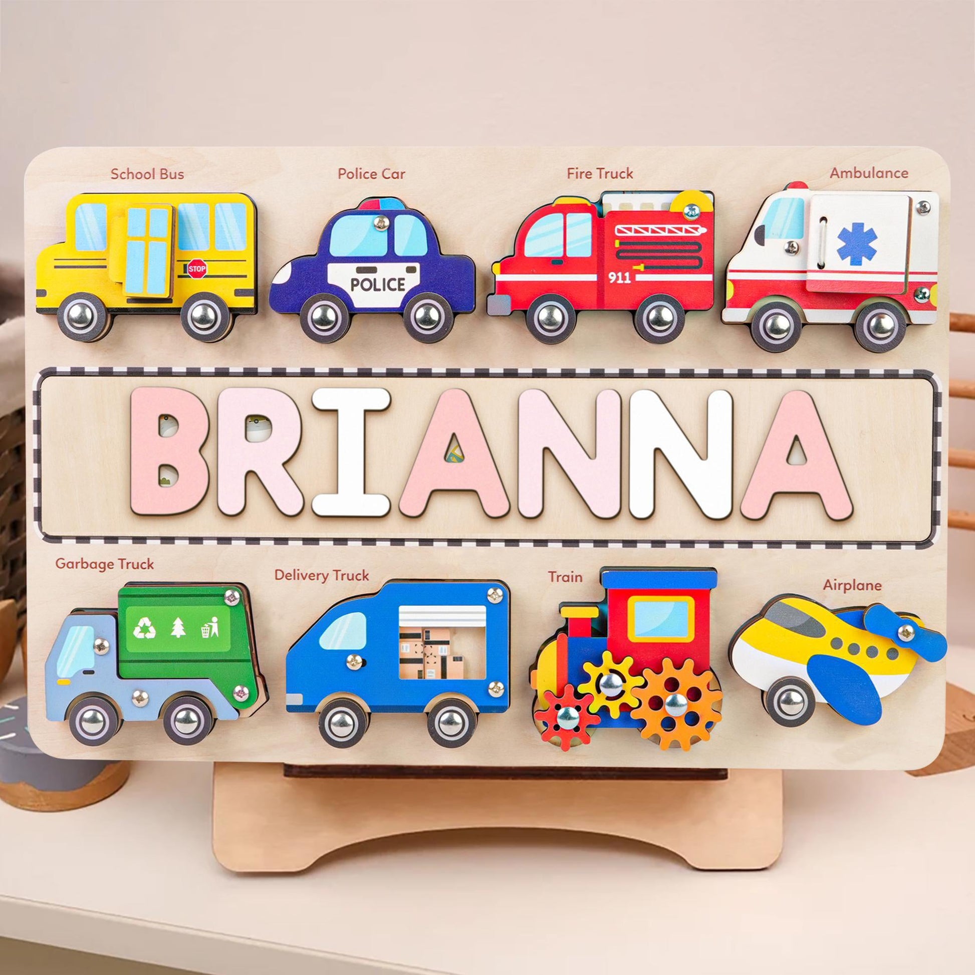 Personalized wooden name puzzle for children featuring colorful vehicles and the name 'Brianna'.