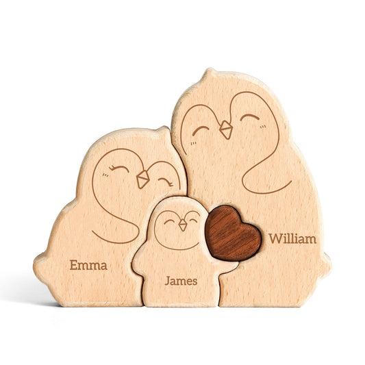 Personalized wooden penguin family puzzle with names Emma, James, and William, symbolizing family love and togetherness.
