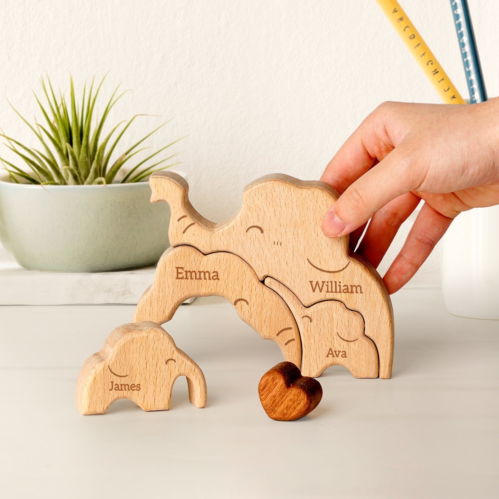 Personalized wooden elephant family puzzle with names Emma, William, and James, perfect for decor and gifts.