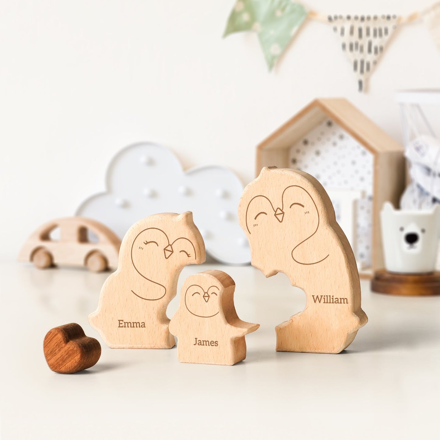 Personalized wooden penguin family puzzle with carved names Emma, James, and William, perfect for family decor.