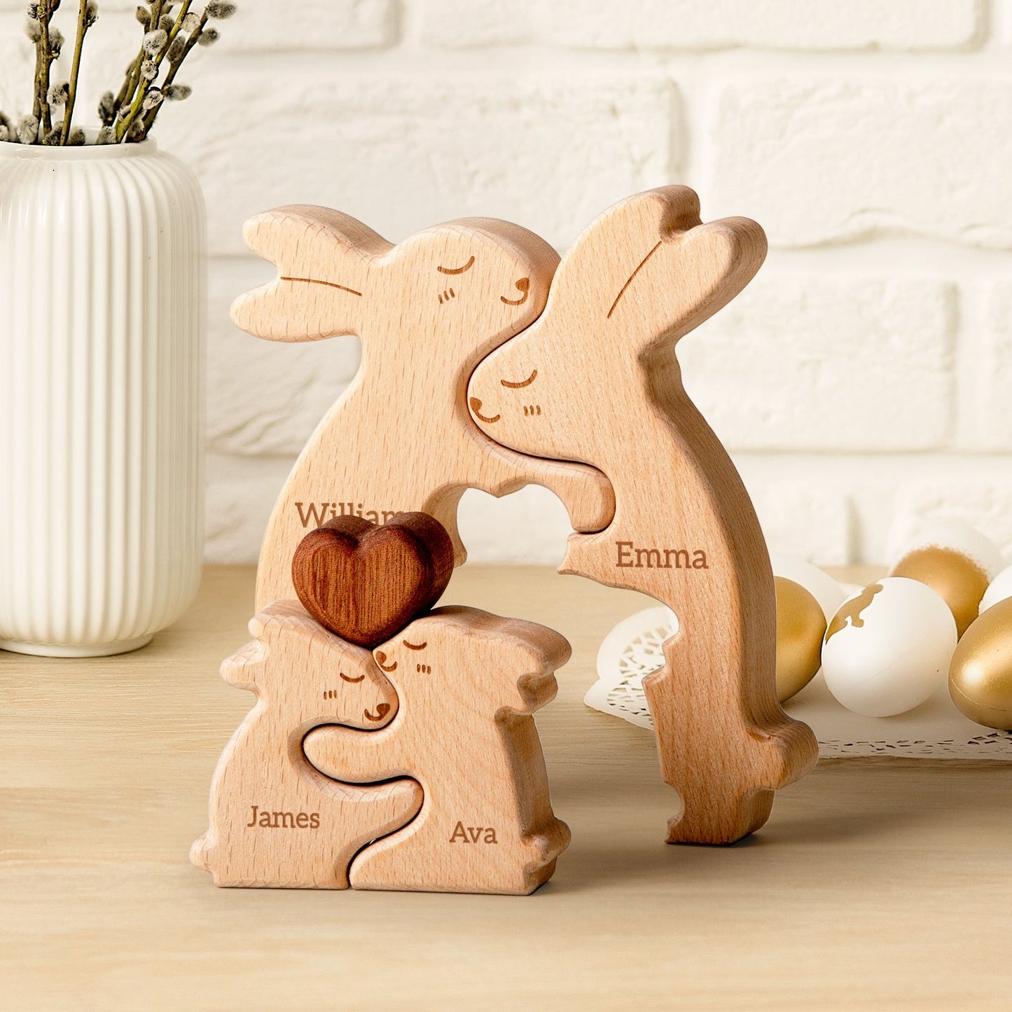 Personalized wooden rabbit family puzzle with names William, Emma, James, and Ava, featuring a heart-shaped piece.
