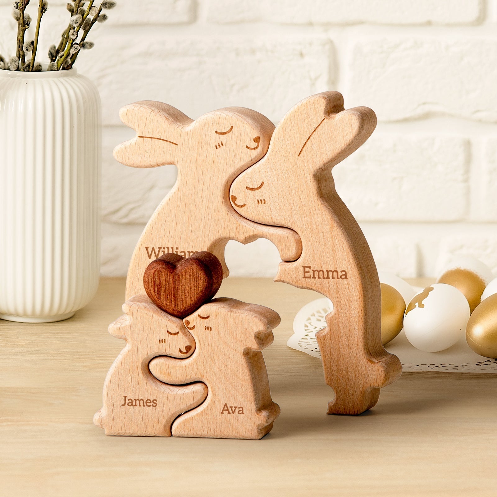 Personalized wooden rabbit family puzzle with names William, Emma, James, and Ava, featuring a heart-shaped piece.