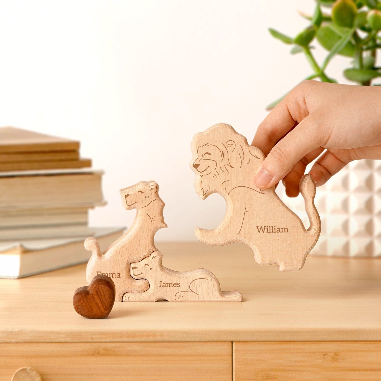 Hand holding personalized wooden lion family puzzle pieces with names, perfect for family decor and gifts.