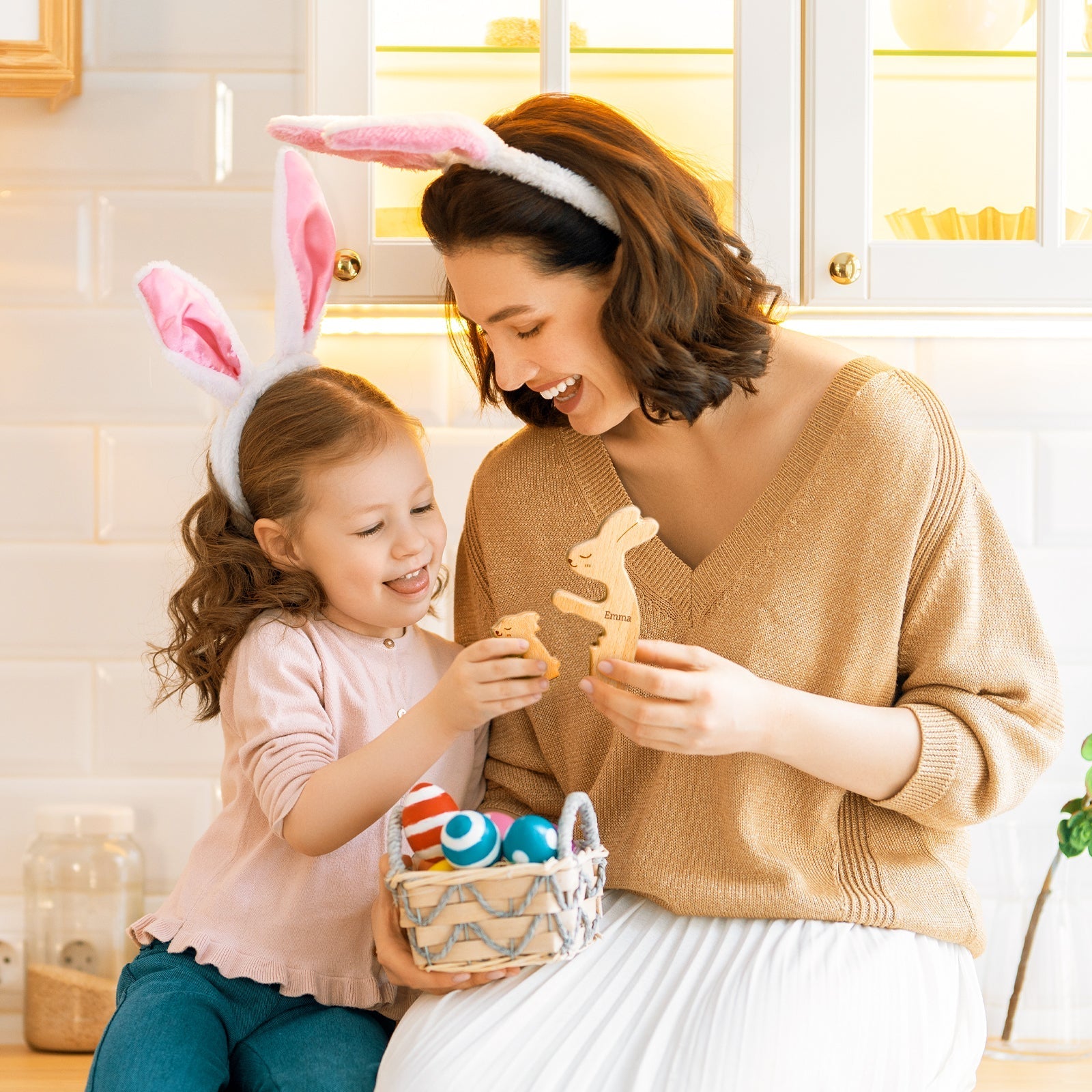 Mother and daughter with bunny ears playing with a personalized wooden rabbit puzzle during Easter celebrations.
