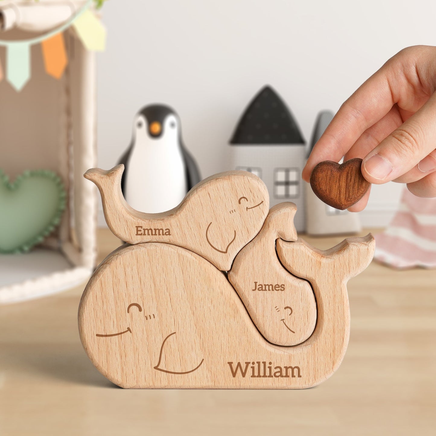Personalized wooden whale family puzzle featuring names Emma, James, and William, ideal for family decor and gifts.