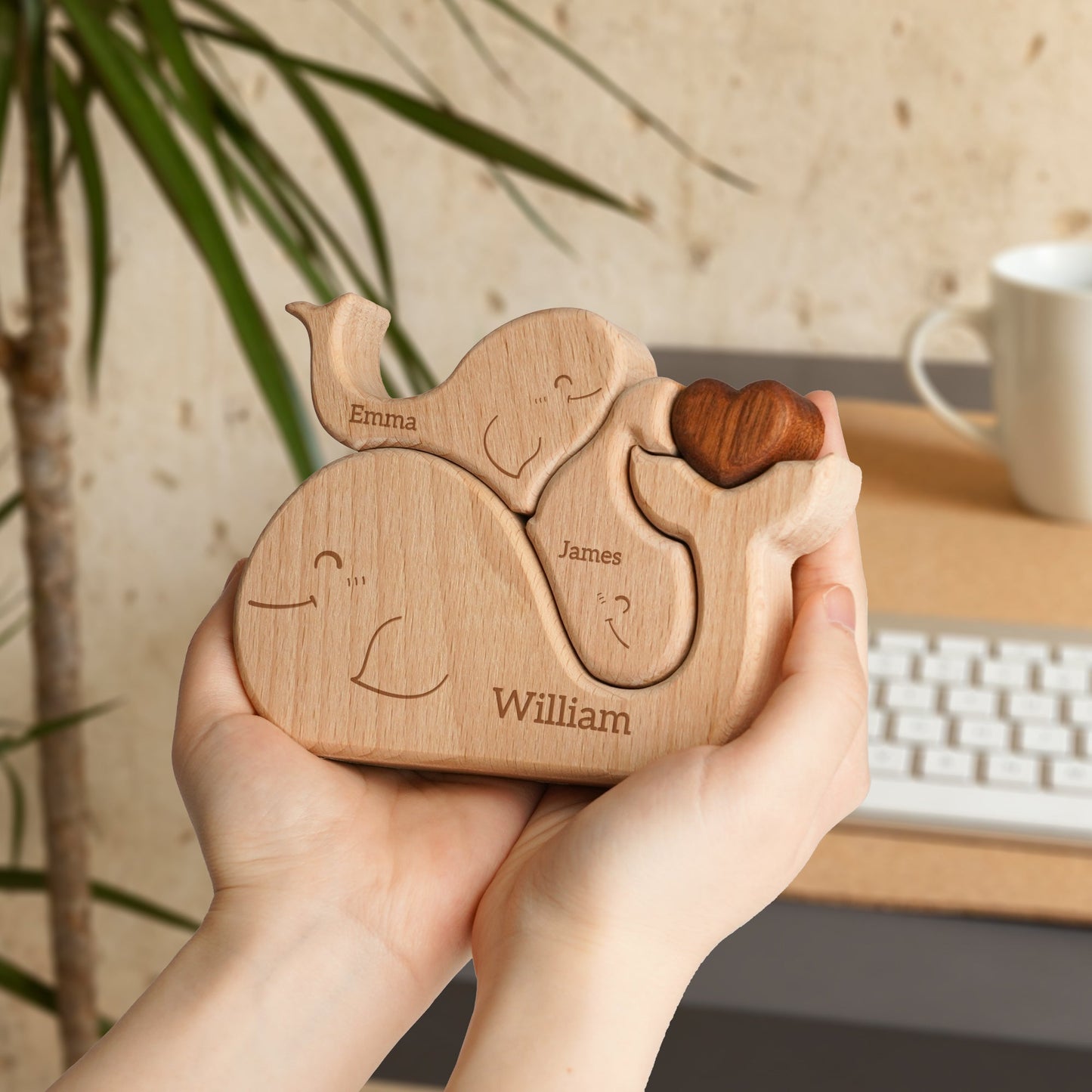 Personalized wooden whale family puzzle showing names Emma, James, and William, symbolizing family love and togetherness.