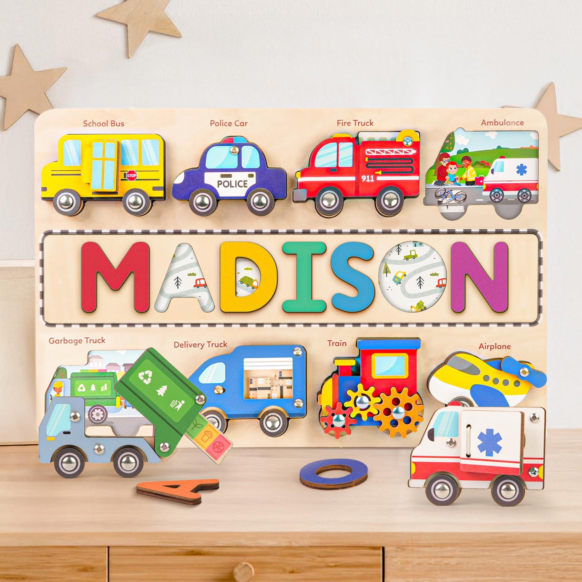 Personalized wooden traffic name puzzle with colorful vehicle pieces and name 'Madison' displayed.